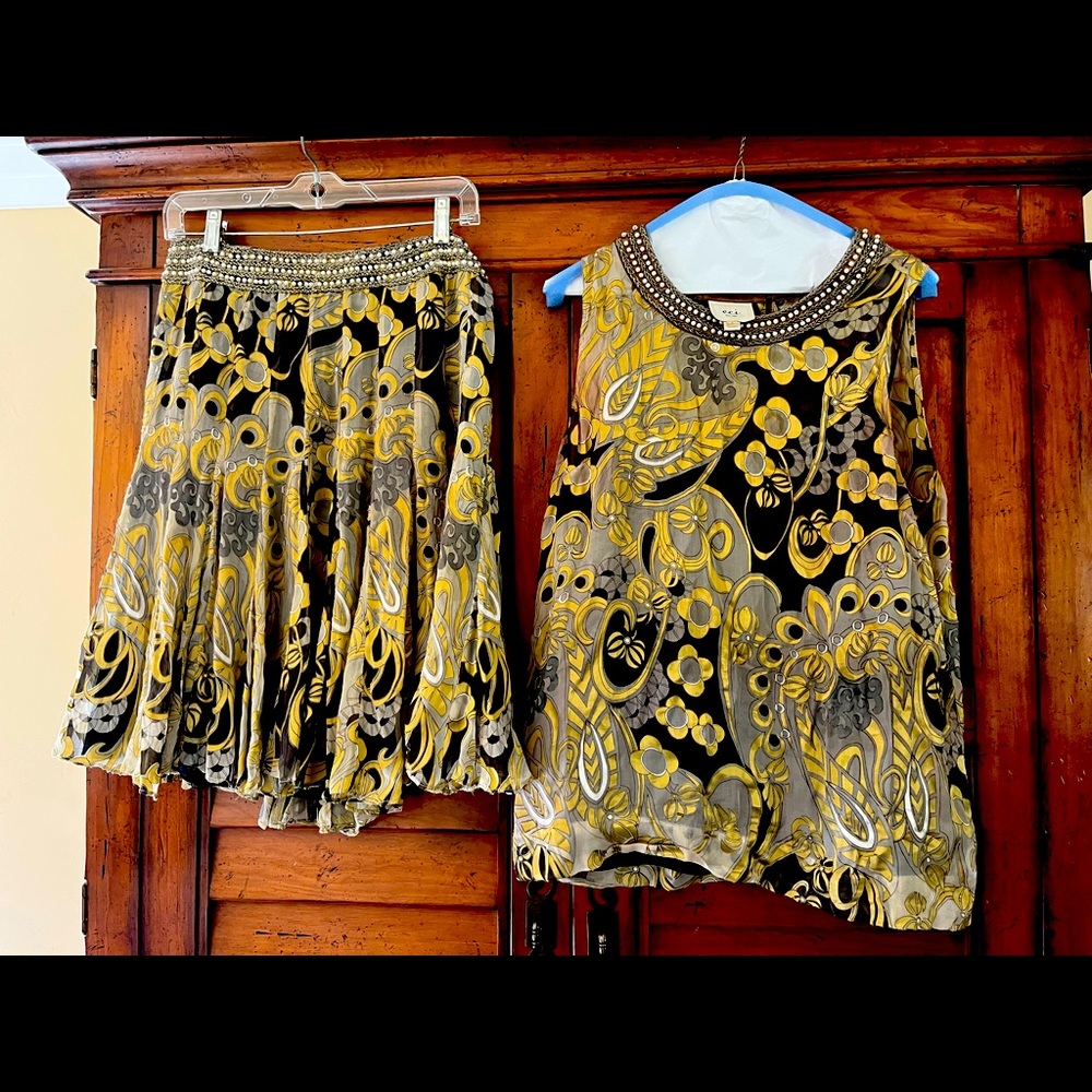 Metallic accents for skirt and top with beadings along collar snd waistline.